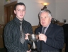 North Antrim Treasurer Chris Campbell presents Shane Hasson the NA Minor Hurling Division Two Trophy